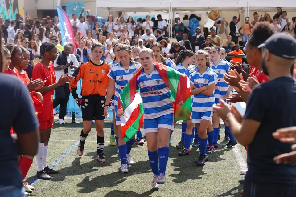 Équipe féminine entrant sur le terrain sous une haie d’honneur